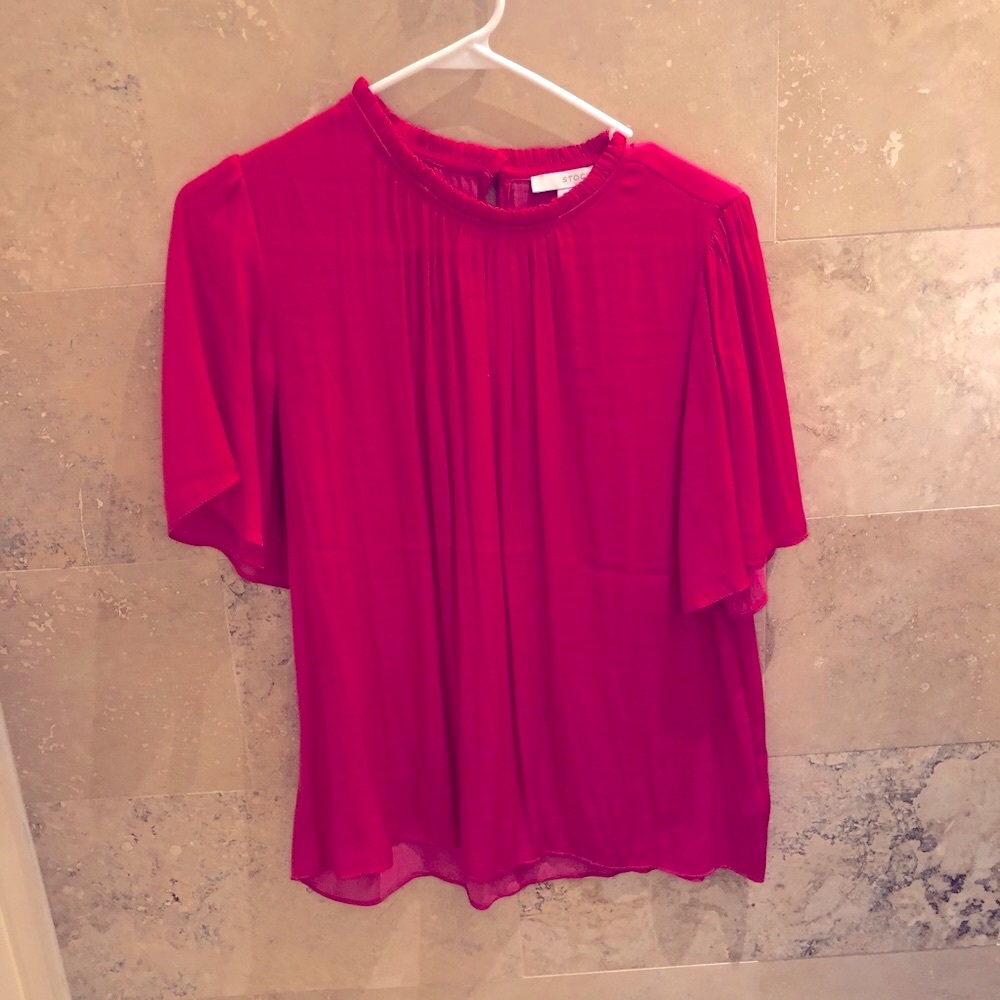Stock hot pink ruffle neck, fluted sleeve top.
